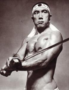 Yukio Mishima (1925-1970) was a Japanese author, playwright and political philosopher who staged a symbolic coup d’état in November 1970, with the ostensible goal of reinstating Japan’s traditional Emperor-centered political system. He committed ritual suicide after the uprising failed to gain traction.
